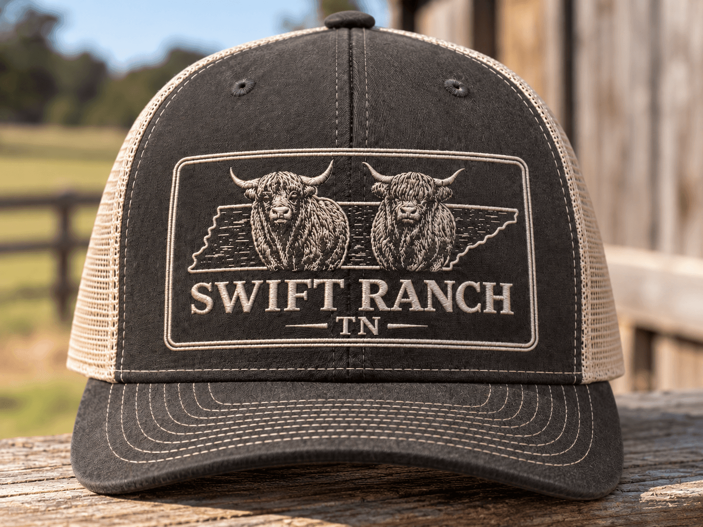 Charcoal trucker hat with tan embroidered Swift Ranch TN Highland cattle logo
